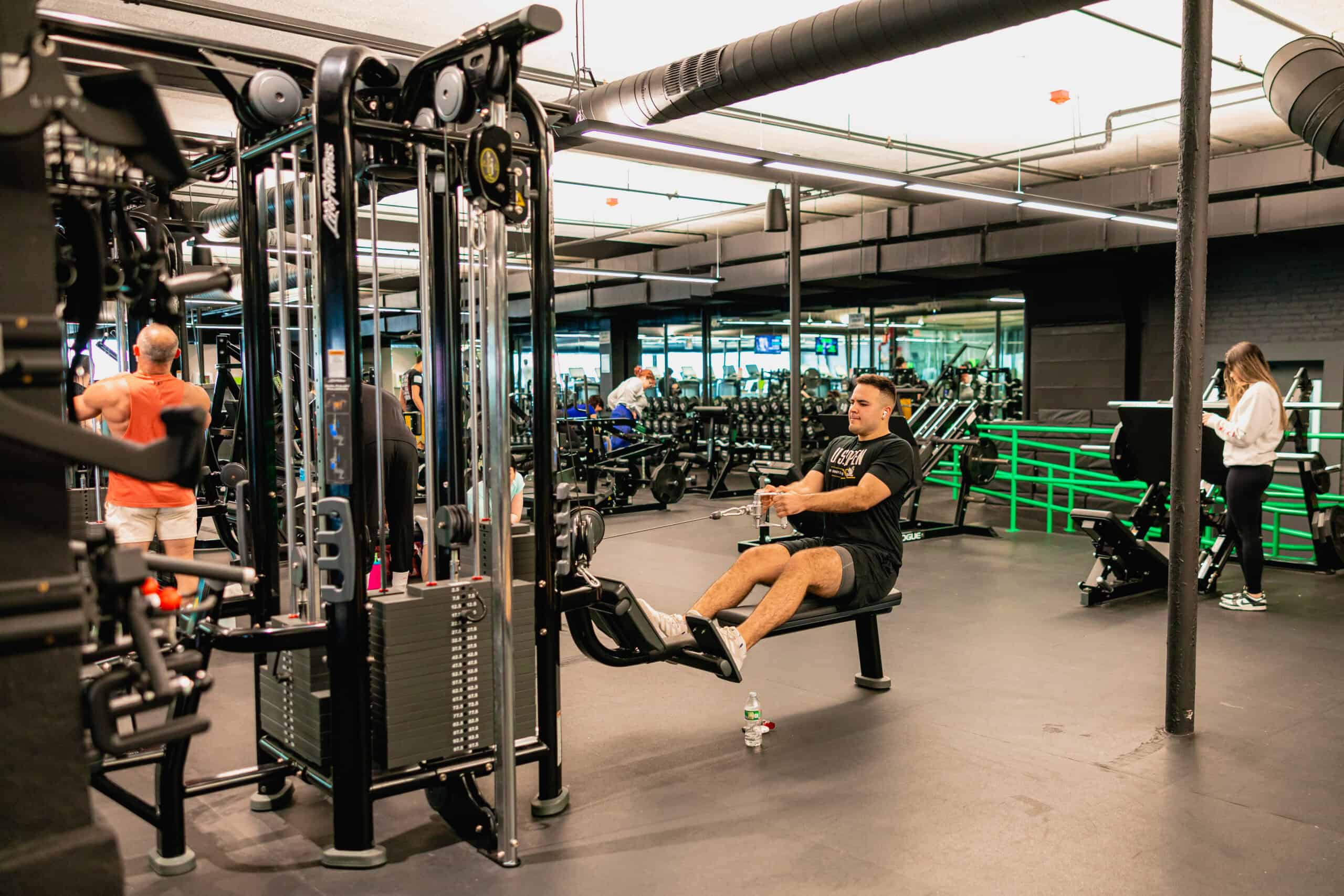 person performing a back row exercise with cable weights